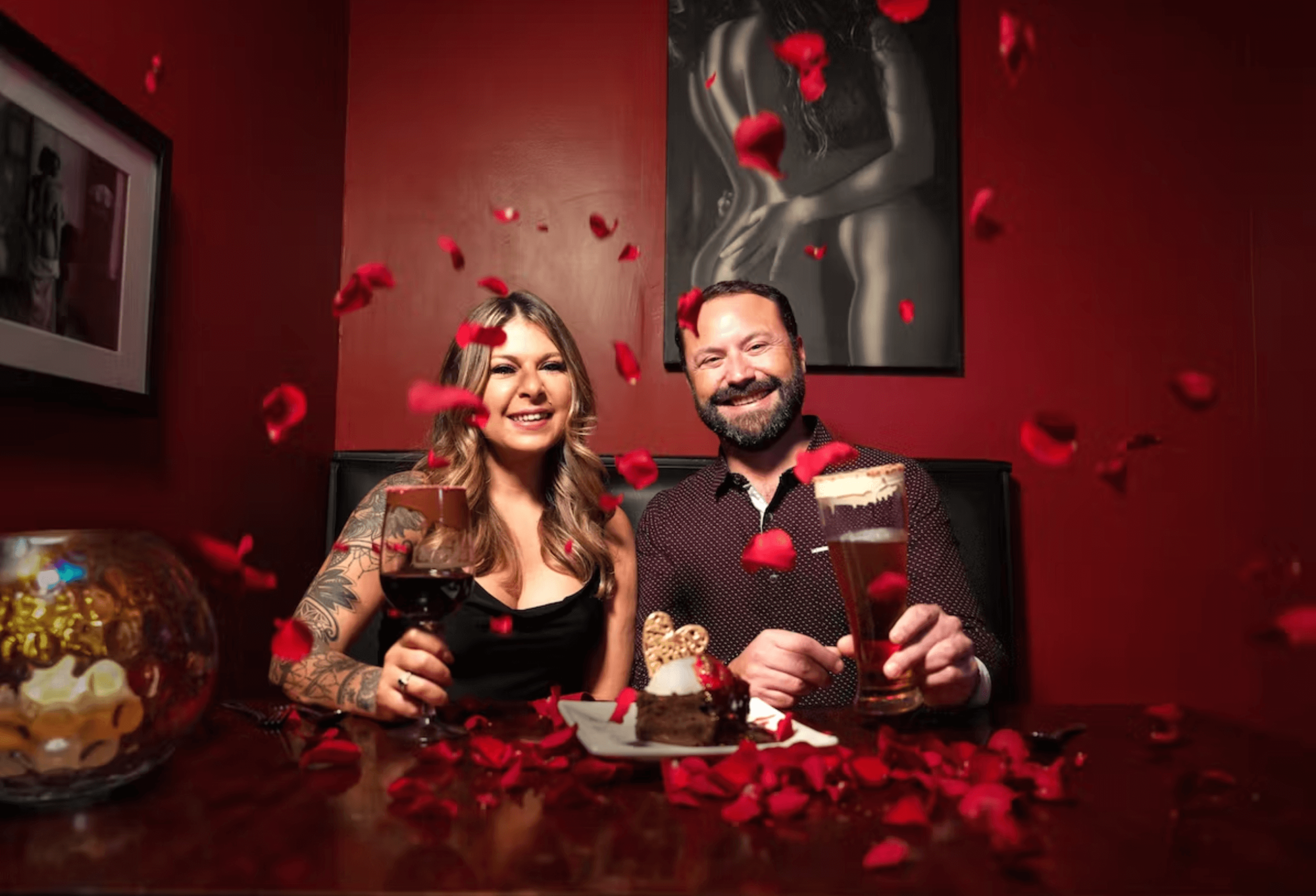 Couple dining with falling rose petals